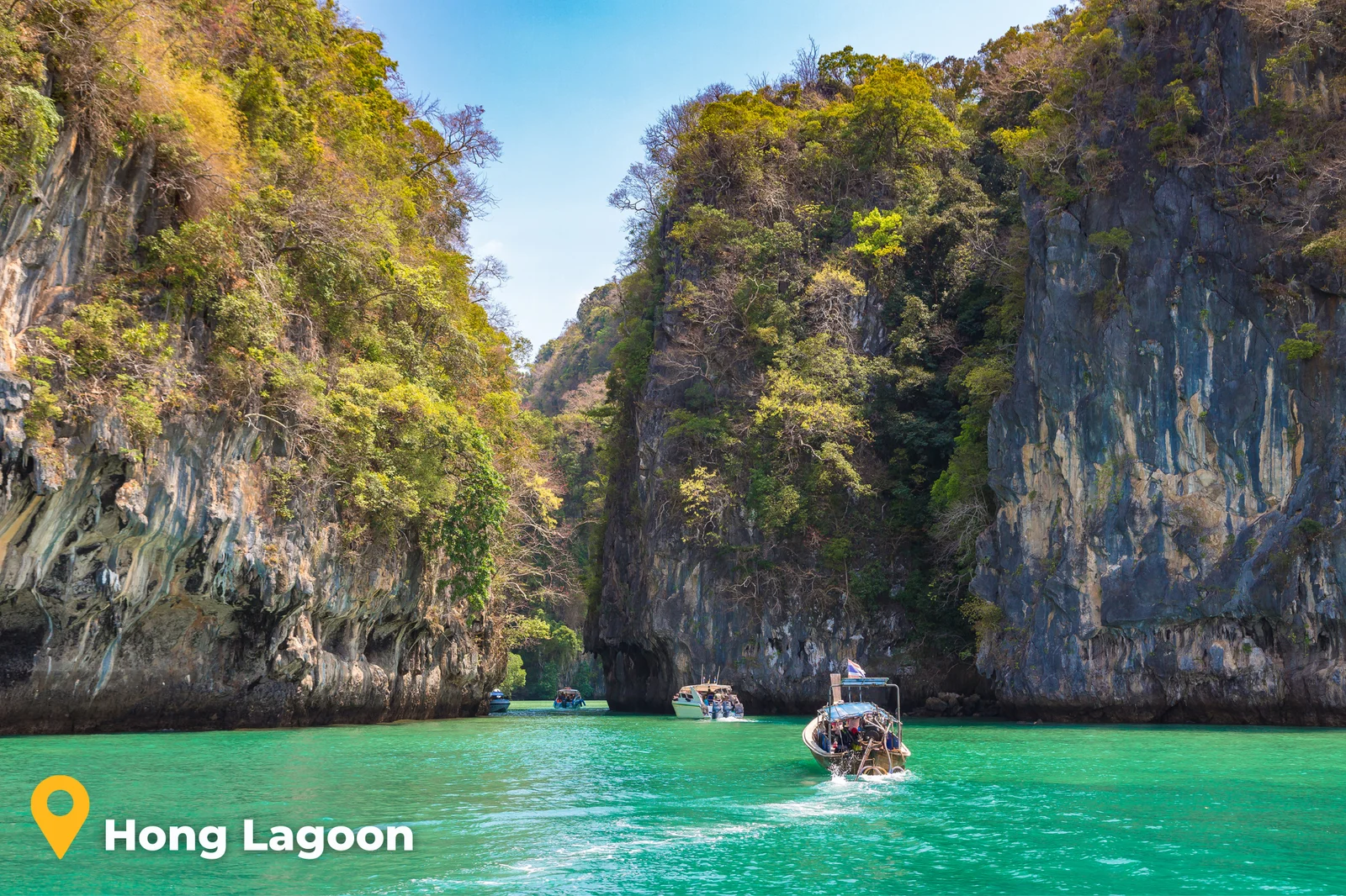 Emerald green lagoon of Hong Island surrounded by limestone cliffs, Phang Nga Bay