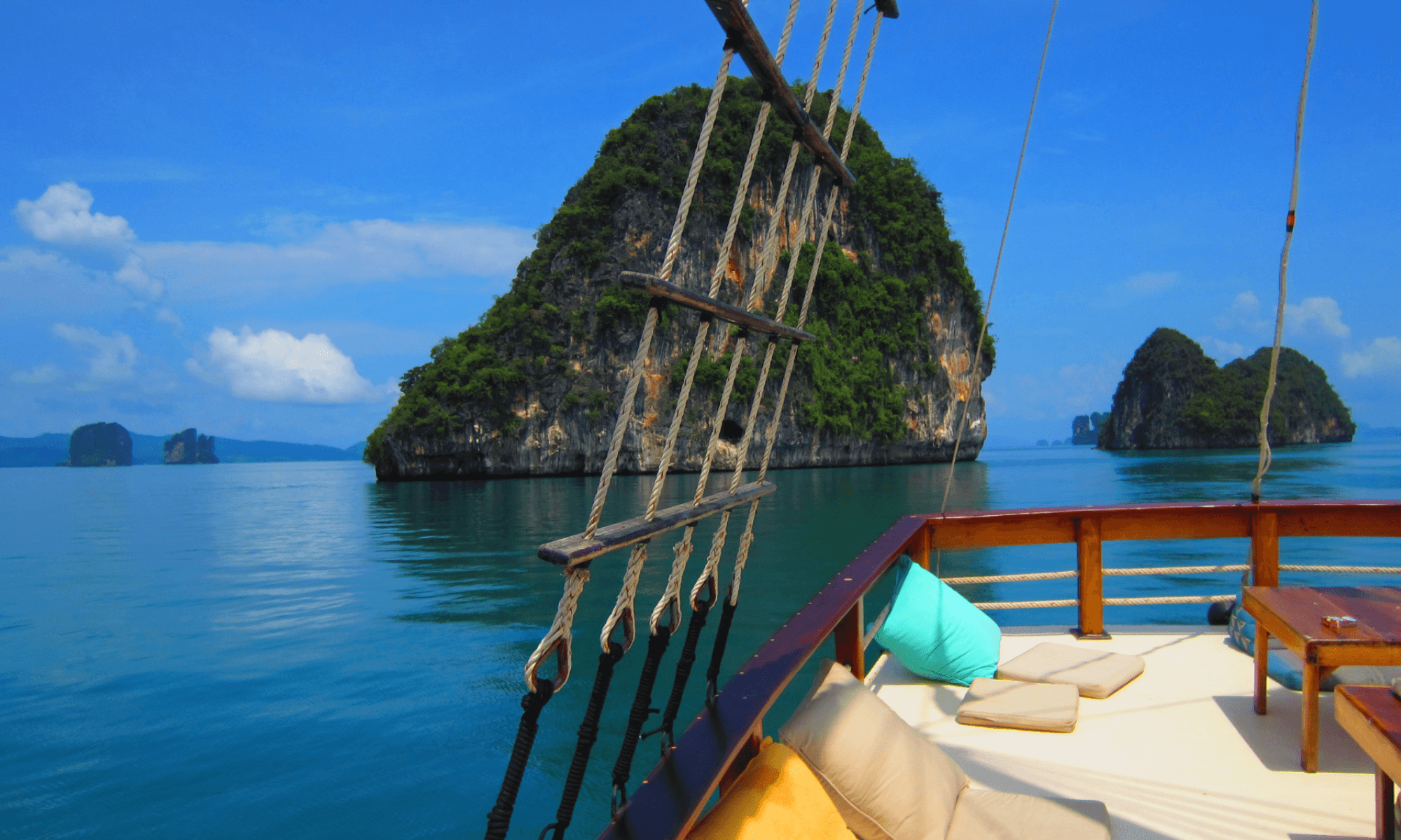 Speedboat cruising past limestone karsts in Phang Nga Bay